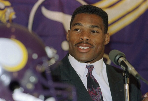 FILE - Former Dallas Cowboys running back Herschel Walker smiles as he is introduced at a news conference to announce the trade of five players and seven draft choices by the Minnesota Vikings for the leading NFC rusher, in Bloomington, Minn., Oct. 13, 1989. The Cowboys launched their dynasty in the 1990s when Jimmy Johnson realized the high value of draft picks and turned Herschel Walker into a huge haul of them. (AP Photo/Jim Mone, File)