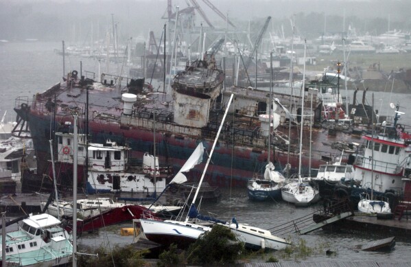 FILE - A large tanker rests on wrecked boats, Sept. 16, 2004, at Brown's Marina in Bayou Chico in Pensacola, Fla. (Douglas R. Clifford/St. Petersburg Times, File)