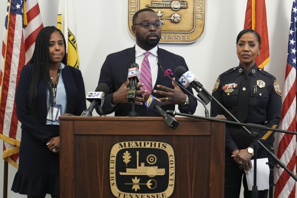 Mayor Paul Young, center, speaks during a news conference with Tannera Gibson, left, and Police Chief Cerelyn "C.J." Davis, right, Thursday, Dec. 5, 2024, in Memphis, Tenn. (AP Photo/George Walker IV)