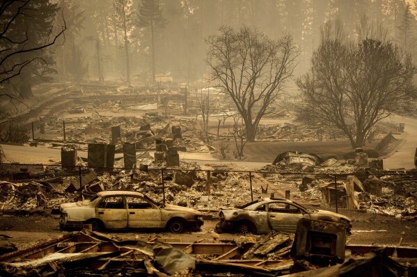 FILE - Homes leveled by the Camp Fire line a development on Edgewood Lane in Paradise, Calif., on Nov. 12, 2018. State Farm will discontinue coverage for 72,000 houses and apartments in California starting summer 2024, the insurance giant said. The Illinois-based company, California's largest insurer, cited soaring costs, the increasing risk of catastrophes like wildfires and outdated regulations as reasons it won’t renew the policies on 30,000 houses and 42,000 apartments, the Bay Area News Group reported Thursday, March 21, 2024. (AP Photo/Noah Berger, File)