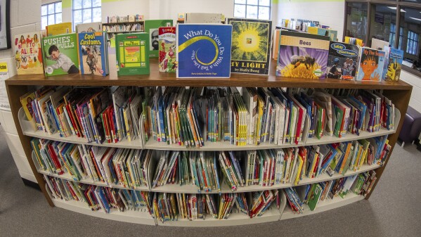 Books sit on shelves in an elementary school library in suburban Atlanta on Friday, 18, 2023. Although not new, book challenges have surged in public schools since 2020, part of a broader backlash to what kids read and discuss in school. (AP Photo/Hakim Wright Sr.)