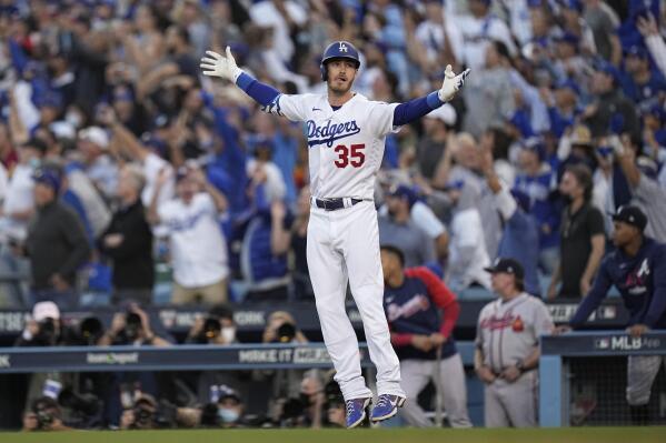 Los Angeles Dodgers center fielder Cody Bellinger reacts after hitting a three-run home run during the eighth inning in Game 3 of baseball's National League Championship Series against the Atlanta Braves Tuesday, Oct. 19, 2021, in Los Angeles. (AP Photo/Jae Hong)