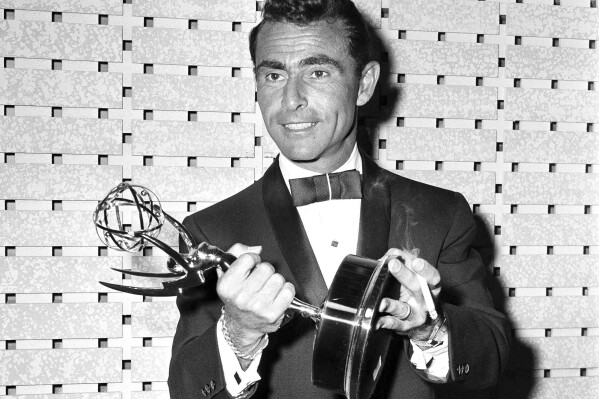 FILE - Writer Rod Serling holds the Emmy for best writing of a drama series for his work on "The Twilight Zone," at the Emmy Awards in Los Angeles on May 16, 1961. (AP Photo, File)