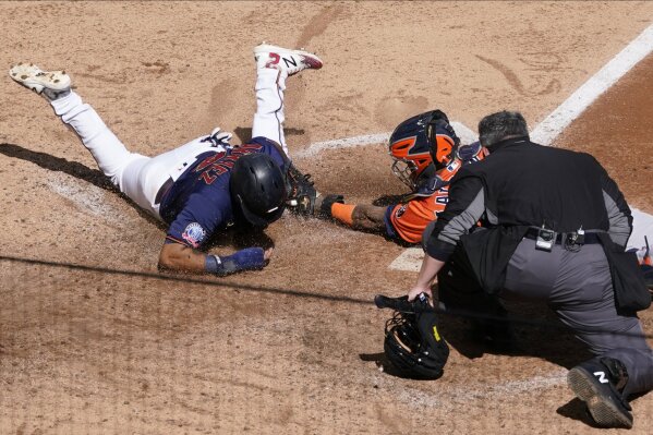 Houston Astros' Marwin Gonzalez, right, is tagged out by Los