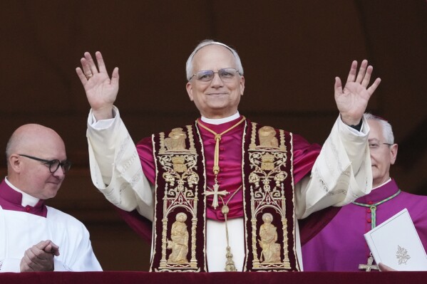 Cardinal Robert Prevost appears on the central loggia of St. Peter's Basilica after being chosen the 267th pontiff of the Roman Catholic Church, choosing the name of Pope Leo XIV, at the Vatican, Thursday, May 8, 2025. (AP Photo/Alessandra Tarantino)