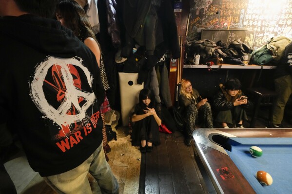 Young punk fans rest during a punk festival in Hangzhou, China, Friday, Jan. 17, 2025. (AP Photo/Aaron Favila)