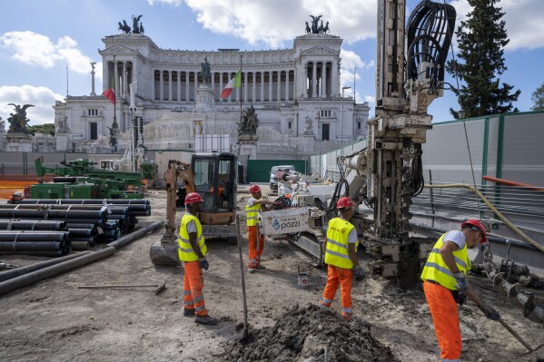 A view of the construction site of the new 25.5-kilometer Metro C subway main hub in Piazza Venezia in central Rome, Thursday, May 23, 2024. During a tour Thursday of the construction site at Piazza Venezia, chief engineer Andrea Sciotti said works on the nearly 3 billion euro project, considered one of the most complicated in the world, were running at pace to be completed by 2034. In the background the Unknown Soldier monument. (AP Photo/Domenico Stinellis)