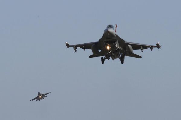 FILE - U.S. Air Force F-16 fighter jets fly over the Osan U.S. Air Base during a combined air force exercise with the United States and South Korea in Pyeongtaek, South Korea, Dec. 4, 2017. The U.S. has once again buckled under pressure from European allies and Ukraine's leaders and agreed to provide more sophisticated weapons to the war effort. This time it's all about F-16 fighter jets. (AP Photo/Ahn Young-joon, File)