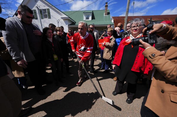 Canada Liberal Leader Mark Carney dawns a Hockey Canada jersey as he makes his way to play ball-hockey with youngsters during a campaign stop in Upper Onslow, Nova Scotia, Canada, Monday, April 21, 2025. (Sean Kilpatrick/The Canadian Press via AP)