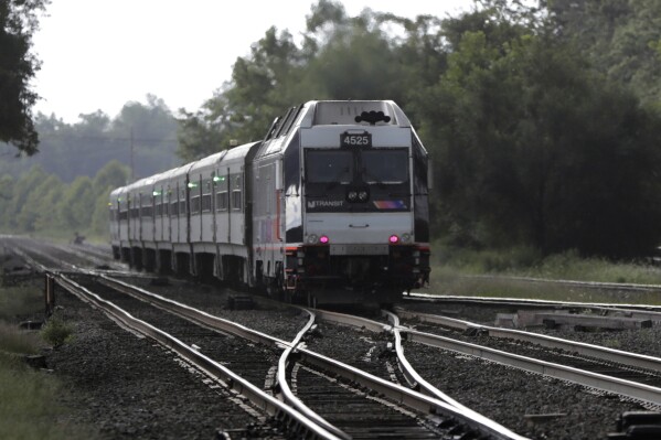 In this Aug. 3, 2018, file photo, a New Jersey Transit train leaves the Bound Brook Station in Bound Brook, N.J. (AP Photo/Julio Cortez, File)