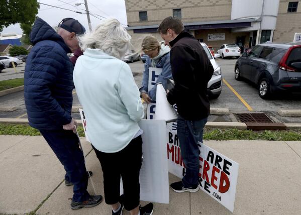 FILE - Anti-abortion protesters from Christ Fellowship Bible Church in Brentwood, Mo., pray on May 3, 2022, outside the Hope Clinic in Granite City, Ill. The U.S. Supreme Court's decision striking down a constitutional right to abortion and sending the issue to the states has groups on both sides of the debate focusing more than ever on races this fall for state supreme courts. (Laurie Skrivan/St. Louis Post-Dispatch via AP, File)