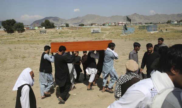 Afghans carry the body of a victim of Dubai City wedding hall bombing during a mass funeral in Kabul, Afghanistan, Sunday, Aug.18, 2019. The deadly bombing at the wedding in Afghanistan's capital late Saturday that killed dozens of people was a stark reminder that the war-weary country faces daily threats not only from the long-established Taliban but also from a brutal local affiliate of the Islamic State group, which claimed responsibility for the attack. (AP Photo/Rafiq Maqbool)