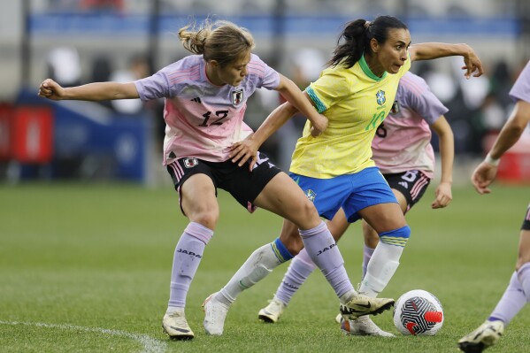 Japan's Rion Ishikawa, left, and Brazil's Marta fight for the ball during the second half of a SheBelieves Cup women's soccer match Tuesday, April 9, 2024, in Columbus, Ohio. (AP Photo/Jay LaPrete)