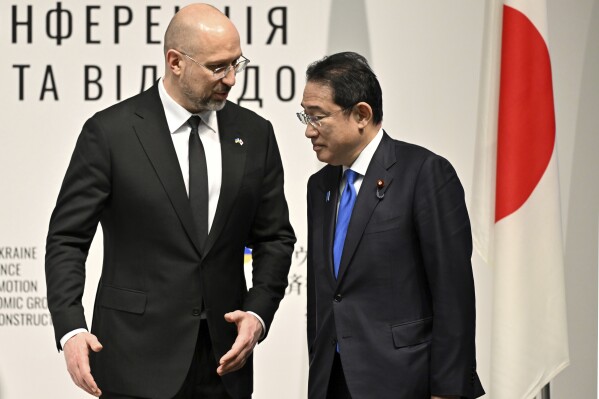 Ukraine's Prime Minister Denys Shmyhal speaks with Japanese Prime Minister Fumio Kishida during the Japan-Ukraine Conference for Promotion of Economic Growth and Reconstruction at Keidanren Kaikan building in Tokyo, Monday, Feb. 19, 2024. (Kazuhiro Nogi/Pool Photo via AP)