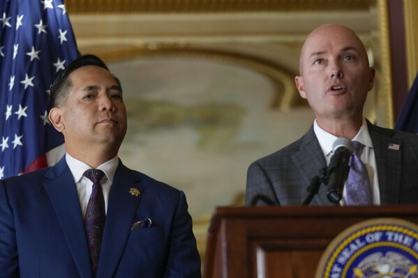 Utah Attorney General Sean Reyes listens as Gov. Spencer Cox speaks during a press conference following the announcement that Utah filed a lawsuit against TikTok at the Utah State Capitol in Salt Lake City, Utah on Tuesday, Oct. 10, 2023. (Bethany Baker/The Salt Lake Tribune via AP)