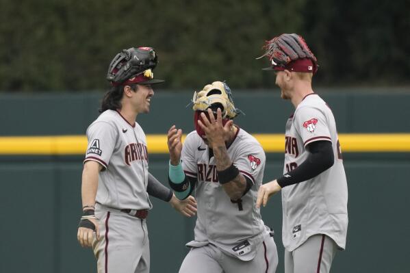 Arizona Diamondbacks left fielder Corbin Carroll, left, center fielder Ketel Marte, center, and right fielder Pavin Smith celebrate the team's 7-5 win over the Detroit Tigers after the ninth inning of a baseball game, Sunday, June 11, 2023, in Detroit. (AP Photo/Carlos Osorio)