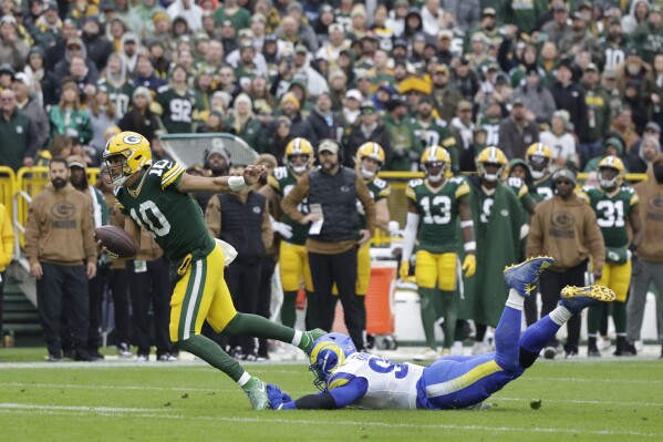 Green Bay Packers quarterback Jordan Love (10) is tackled by Los Angeles Rams defensive tackle Aaron Donald (99) during the second half of an NFL football game Sunday, Nov. 5, 2023, in Green Bay, Wis. (AP Photo/Matt Ludtke)