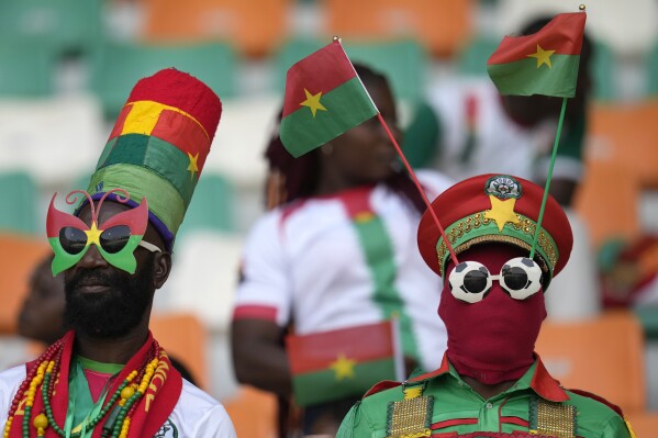 Burkina Faso fans cheer before the start of the African Cup of Nations round of 16 soccer match between Mali and Burkina Faso, at the Amadou Gon Coulibaly stadium in Korhogo, Ivory Coast, Tuesday, Jan. 30, 2024. (AP Photo/Themba Hadebe)