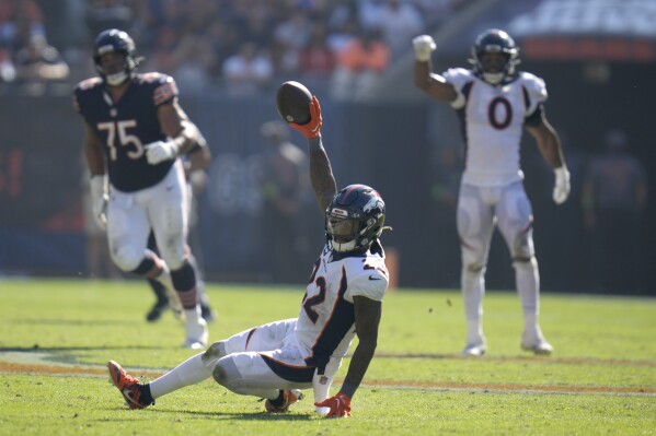 Denver Broncos safety Kareem Jackson goes to the ground and celebrates his game winning interception of a pass by Chicago Bears quarterback Justin Fields during the second half an NFL football game Sunday, Oct. 1, 2023, in Chicago. The Broncos won 31-28.(AP Photo/Erin Hooley)