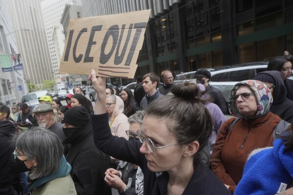 A person holds up a sign during a news conference and rally by immigrant justice organizations and advocates protesting ICE arrests in San Francisco, Wednesday, May 28, 2025. (AP Photo/Jeff Chiu, File)