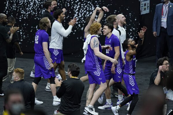 Abilene Christian players celebrate after upsetting Texas 53-52 in a college basketball game in the first round of the NCAA tournament at Lucas Oil Stadium in Indianapolis Sunday, March 21, 2021. (AP Photo/Mark Humphrey)