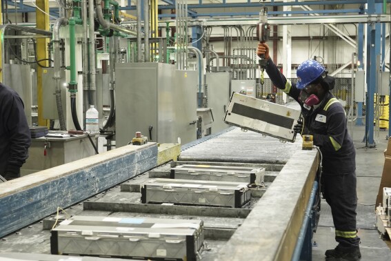 This undated photo provided by Ascend Elements shows a team member loading used electric vehicle battery modules onto a massive shredder at the Ascend Elements battery recycling facility in Covington, Ga. A recycling facility will be built in Hopkinsville, Ky., to shred electric vehicle batteries in a $65 million venture between American and South Korean companies — Ascend Elements and SK ecoplant, respectively — that will supply material for a separate battery-related operation in the same town, the companies announced Tuesday, Sept. 26, 2023. (Ascend Elements via AP)