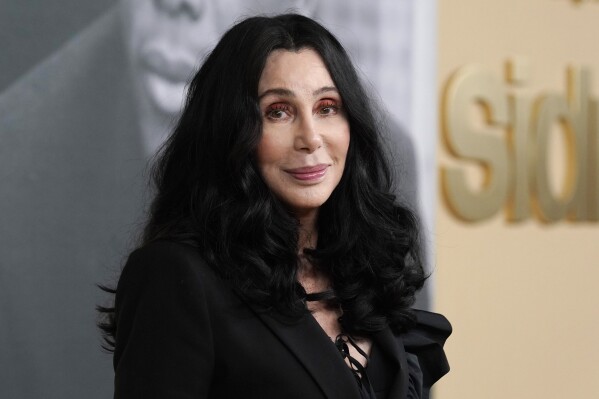FILE - Cher poses at the premiere of the documentary film "Sidney," Sept. 21, 2022, in Los Angeles. Cher has filed a petition to become a temporary conservator overseeing her son's money, saying his struggles with mental health and substance abuse have left him unable to manage his assets and potentially put his life in danger. The Oscar and Grammy winning singer and actor on Wednesday, Dec. 27, 2023, filed the petition in Los Angeles Superior Court that would give her temporary control of the finances of Elijah Blue Allman, her 47-year-old son with musician Gregg Allman. (AP Photo/Chris Pizzello, File)