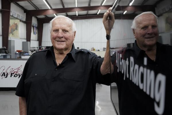 A.J. Foyt stands inside his racing team's garage, Wednesday, March 29, 2023, in Waller, Texas. Foyt has defied death more times than anyone count. From killer bees and capsized boats to triple bypass surgery and terrifying racing accidents, the first four-time winner of the Indianapolis 500 has made it to 88 years old with an irreverent view about death. (AP Photo/Godofredo A. Vásquez)