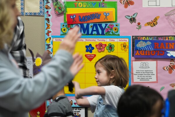 The day of the school's closure is marked on a calendar as children, including Mariah Wallen, 5, march in a circle to music in the Stars classroom at the Meadow Lakes CCS Early Learning, a Head Start center, Monday, May 6, 2024, in Wasilla, Alaska. (AP Photo/Lindsey Wasson)