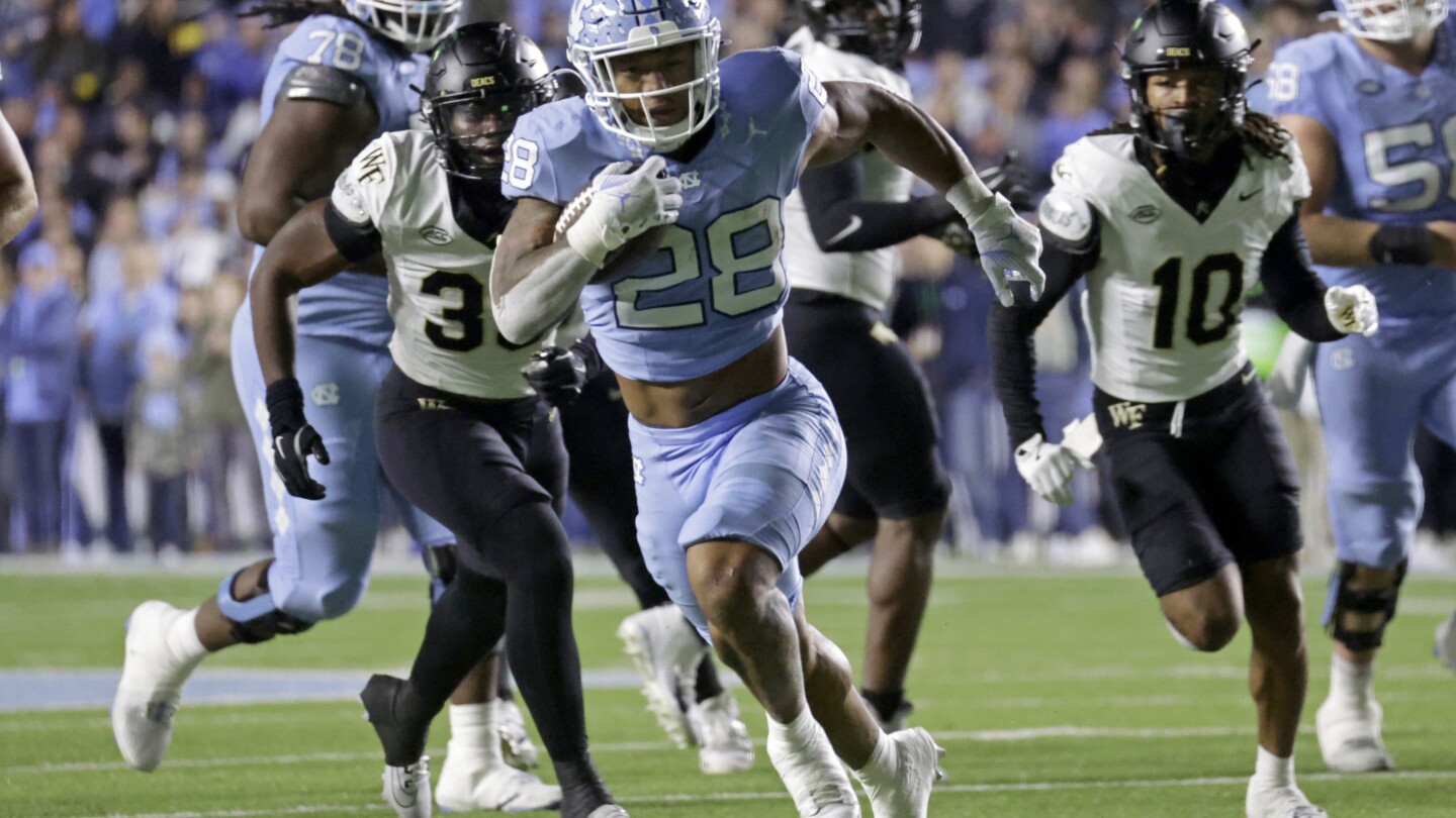 Hampton’s huge day helps North Carolina hold off Wake Forest 31-24 to reach bowl eligibility
