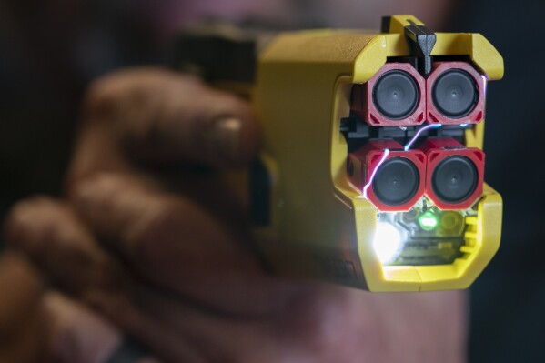 Arcs of electricity flow as an Axon TASER 7, with a red inert training cartridge, is fired during a demonstration, Thursday, May 12, 2022, in Washington. (AP Photo/Jacquelyn Martin)