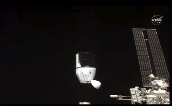 This photo provided by NASA shows SpaceX's Dragon undocking from International Space Station on Tuesday, Jan. 12, 2021.  SpaceX's Dragon cargo capsule undocked with 12 bottles of Bordeaux wine and hundreds of snippets of Merlot and Cabernet Sauvignon vines. The capsule is aiming for a splashdown in the Gulf of Mexico off the Florida coast Wednesday night. (NASA via AP)