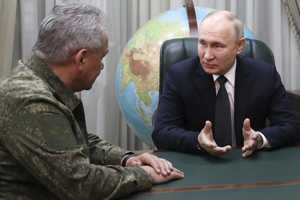 FILE - Russian President Vladimir Putin, right, gestures while speaking to Defense Minister Sergei Shoigu at the headquarters of the Southern Military District in Rostov-on-Don, Russia, on Thursday, Nov. 9, 2023. Putin seems to be hoping that relentless military pressure, combined with changing Western political dynamics and a global focus on the Israeli-Hamas war, will drain support for Ukraine in the nearly 2-year-old war and force Kyiv to yield to Moscow's demands. Putin is eager to show battlefield gains in Ukraine as he faces reelection in March. (Gavriil Grigorov, Sputnik, Kremlin Pool Photo via AP, File)