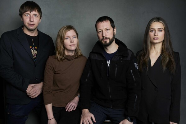 FILE - Photographer Evgeniy Maloletka, from left, "Frontline" producer/editor Michelle Mizner, director Mstyslav Chernov, and field producer Vasilisa Stepanenko pose for a portrait to promote the film "20 Days in Mariupol" at the Latinx House during the Sundance Film Festival on Sunday, Jan. 22, 2023, in Park City, Utah. The “Frontline” documentary collaboration with The Associated Press premieres on PBS on Nov. 21. (Photo by Taylor Jewell/Invision/AP, File)