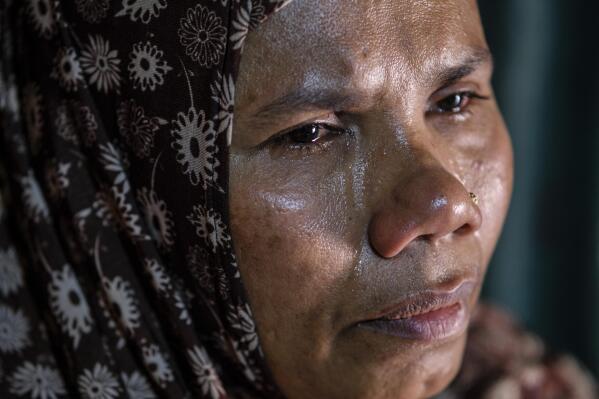 Bulbul, a Rohingya refugee and the sister of the missing boat’s captain, Jamal Hussein, cries as she shares memories of her brother during an interview at her shelter in a Rohingya refugee camp in the Cox's Bazar district of Bangladesh, on March 5, 2023. (AP Photo/Mahmud Hossain Opu)