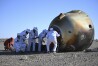 In this photo released by Xinhua News Agency, workers open up the capsule of the Shenzhou-17 manned spaceship after it lands successfully at the Dongfeng landing site in north China's Inner Mongolia Autonomous Region, Tuesday, April 30, 2024. China's Shenzhou-17 spacecraft returned to Earth Tuesday, carrying three astronauts who have completed a six-month mission aboard the country's orbiting space station. (Lian Zhen/Xinhua via AP)