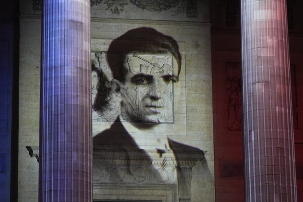 The portrait of Missak Manouchian is projected on the facade of Pantheon monument, Wednesday, Feb. 21, 2024 in Paris. While France hosts grandiose ceremonies commemorating D-Day, Missak Manouchian and his Resistance fighters' heroic role in APWar II are often overlooked. French President Emmanuel Macron is seeking to change that by inducting Manouchian into the Panth茅on national monument. (APPhoto/Michel Euler)