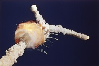 FILE - In this Jan. 28, 1986 file photo, the space shuttle Challenger explodes shortly after lifting off from the Kennedy Space Center in Cape Canaveral, Fla. Weaver, a Florida-based photographer who captured a definitive image of space shuttle Challenger breaking apart into plumes of smoke and fire after liftoff, has died. He was 77. A statement released by the North Brevard Funeral Home said Weaver died in his sleep Friday, Oct. 6, 2023, with his wife and family by his side. He was living in Titusville, Fla., along the state's Space Coast. (AP Photo/Bruce Weaver, File)