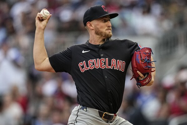 Cleveland Guardians pitcher Tanner Bibee (28) delivers in the first inning of a baseball game against the Atlanta Braves, Saturday, April 27, 2024, in Atlanta. (AP Photo/Mike Stewart)