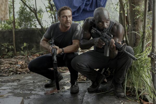 This image released by Lionsgate shows Gerard Butler, left, and Mike Colter in a scene from "Plane." (Kenneth Rexach/Lionsgate via AP)