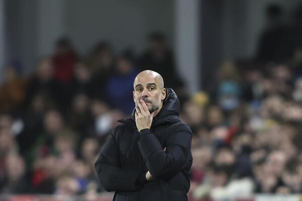 Manchester City's head coach Pep Guardiola watches during the English Premier League soccer match between Brentford and Manchester City at the Brentford Community Stadium in London, Wednesday, Dec. 29, 2021. (AP Photo/Ian Walton)