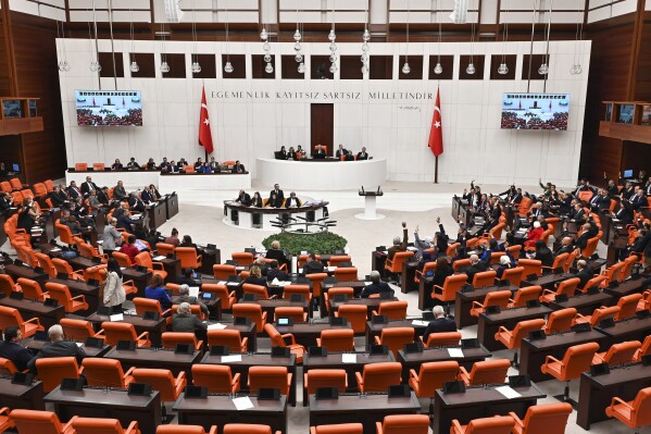 Turkish lawmakers follow the debate of Sweden's bid to join NATO at the Turkish Parliament in Ankara, Turkey, Tuesday, Jan. 23, 2024. Turkish legislators on Tuesday endorsed Sweden's membership in NATO, lifting a major hurdle on the previously nonaligned country's entry into the military alliance. (AP Photo/Ali Unal)