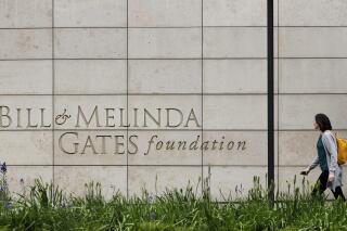 FILE - A person walks by the headquarters of the Bill and Melinda Gates Foundation on April 27, 2018, in Seattle. The Bill and Melinda Gates Foundation announced Sunday, Oct. 16, 2022, that it will commit $1.2 billion to the effort to end polio worldwide. (AP Photo/Ted S. Warren, File)