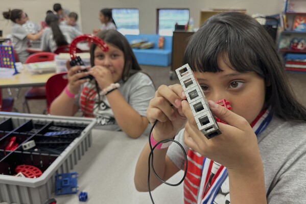 Loving Elementary School students participate in a science, technology, engineering and math lab supported by The Ripken Foundation and Devon Energy, in Loving, N.M., on Monday, May 19, 2025. (AP Photo/Susan Montoya Bryan)