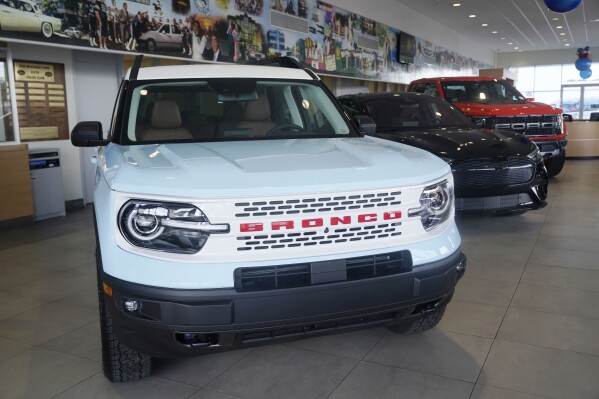 File -A Ford Bronco is displayed at a Gus Machado Ford dealership on Jan. 23, 2023, in Hialeah, Fla. New union agreements with Detroit automakers reached during the past week will cost Ford, Stellantis and General Motors over $1 billion per year by the time they take effect in four years. (AP Photo/Marta Lavandier, File)