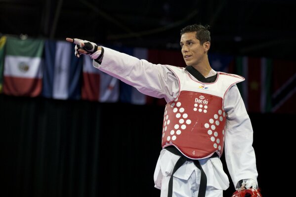 
              FILE - In this July 21, 2015 file photo, United States' Steven Lopez celebrates winning a bronze medal by defeating Venezuela's Javier Medina in the men's taekwondo under-80kg category at the Pan Am Games in Mississauga, Ontario. The U.S. Center for SafeSport has on Thursday, Sept. 6, 2018, permanently banned the two-time Olympic taekwondo champion for sexual misconduct involving a minor. (AP Photo/Rebecca Blackwell, File)
            