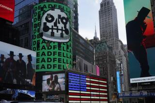 FILE - An NFT, or non-fungible token, is displayed on a billboard in Time Square, New York, on Nov. 4, 2021. Collins Dictionary has chosen the term NFT as its word of the year after surging interest in the digital tokens that can sell for millions of dollars brought it into the mainstream. NFT is short for non-fungible token. Collins defines it as “a unique digital certificate, registered in a blockchain, that is used to record ownership of an asset such as an artwork or a collectible." (AP Photo/Seth Wenig)