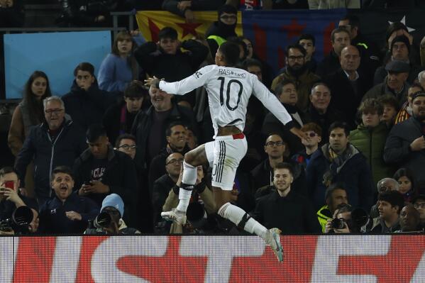 Manchester United's Marcus Rashford celebrates after scoring his side's opening goal during the Europa League playoff first leg soccer match between Barcelona and Manchester United at the Camp Nou stadium in Barcelona, Spain, Thursday, Feb. 16, 2023. (AP Photo/Joan Monfort)