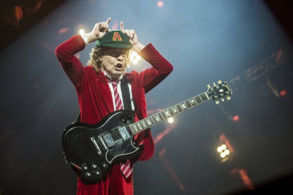 FILE - Angus Young, of AC/DC, performs at Nationwide Arena on Sept. 4, 2016, in Columbus, Ohio.  After 47 years, the band is releasing its 17th studio album, “Power Up,” on Friday. (Photo by Amy Harris/Invision/AP, File)