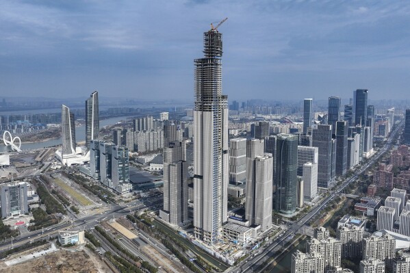 FILE - This photo released by Xinhua News Agency shows an aerial view of the construction site of the 2nd phase project of the Nanjing Financial City designed as an architectural complex comprising offices, hospitality, housing and commercial facilities in Nanjing, east China's Jiangsu Province, on Jan. 16, 2024. China was preparing to announce fresh measures to reinvigorate its ailing property industry after data released Friday, May 17, 2024 showed housing prices slumped in the first four months of the year, although factory output rose nearly 7%. (Li Bo/Xinhua via AP, File)